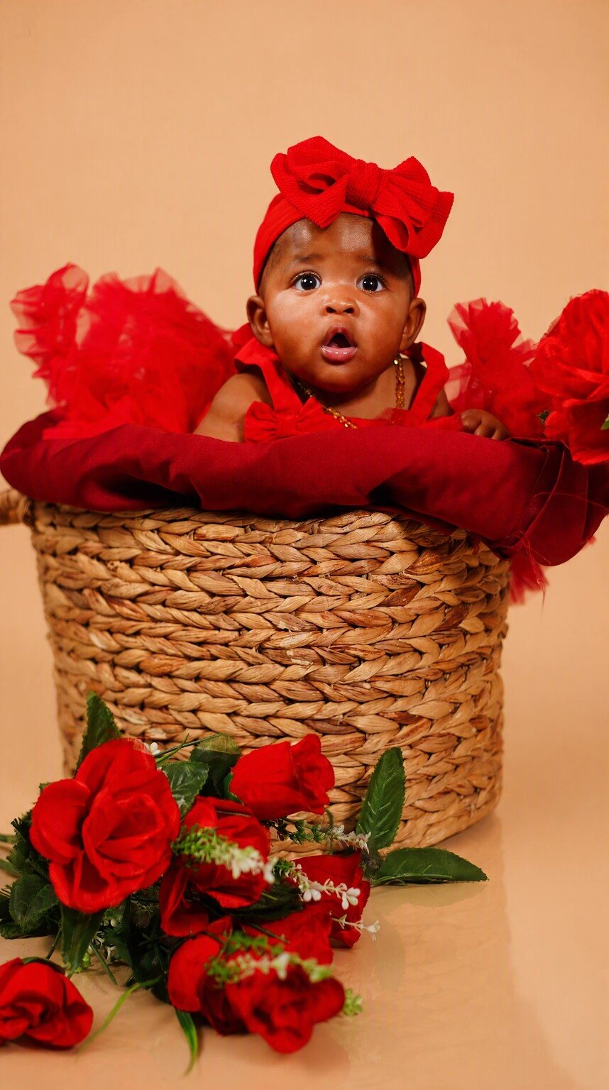 Baby portrait styled with red flowers